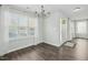 Inviting entryway featuring wood flooring, neutral paint, chandelier and a sunlit seating area at 938 Widewaters Pkwy, Knightdale, NC 27545