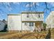 View of the rear home exterior featuring vinyl siding and a walk-out basement at 938 Widewaters Pkwy, Knightdale, NC 27545