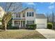 Charming two-story home with a manicured lawn, inviting front porch, and a two-car garage at 938 Widewaters Pkwy, Knightdale, NC 27545