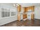 Bright kitchen with wooden cabinets, white appliances, and a window above the sink at 938 Widewaters Pkwy, Knightdale, NC 27545