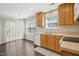 Eat-in kitchen area with wood flooring, lots of natural light and white dishwasher at 938 Widewaters Pkwy, Knightdale, NC 27545