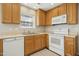 The well-lit kitchen boasts ample storage space with light wood cabinets and white appliances at 938 Widewaters Pkwy, Knightdale, NC 27545