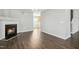 Open living space with sleek floors, a fireplace, and seamless transition to the kitchen and staircase at 938 Widewaters Pkwy, Knightdale, NC 27545