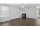 Cozy living room features sleek floors, a charming fireplace, and neutral decor, creating a welcoming space at 938 Widewaters Pkwy, Knightdale, NC 27545