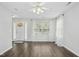 Bright living room featuring sleek floors, large windows, ceiling fan, and neutral tones at 938 Widewaters Pkwy, Knightdale, NC 27545