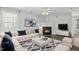 Inviting living room showcasing a fireplace, plush seating, stylish decor, and neutral color palette at 938 Widewaters Pkwy, Knightdale, NC 27545