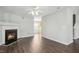 Spacious living area with a fireplace, sleek floors, and a view into the kitchen, bathed in natural light at 938 Widewaters Pkwy, Knightdale, NC 27545