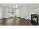 Cozy living room features a fireplace, wood floors, and sheer curtains for a warm and inviting atmosphere at 938 Widewaters Pkwy, Knightdale, NC 27545