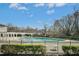 Community pool featuring a pool deck, pergola and mature trees at 938 Widewaters Pkwy, Knightdale, NC 27545