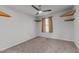 Carpeted bedroom with wooden shelves and standard-size window with curtains at 95 Westbrook Ln, Franklinton, NC 27525