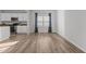 Spacious room shows open-concept design with a modern kitchen featuring white cabinets and wood-look flooring at 95 Westbrook Ln, Franklinton, NC 27525