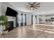 Open-concept living room with wood-look floors, a fireplace, and seamless flow into the modern kitchen at 95 Westbrook Ln, Franklinton, NC 27525