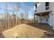 Backyard featuring freshly seeded lawn, with a view of the trees and neighborhood homes at 100 Sire Ct, Holly Springs, NC 27540