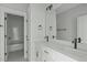 Bright bathroom featuring double sinks, a large mirror, and access to the shower/tub combo at 100 Sire Ct, Holly Springs, NC 27540
