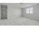 Neutral-toned bedroom featuring a bright window and plush carpet at 100 Sire Ct, Holly Springs, NC 27540
