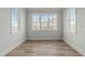 Bedroom with hardwood floors and bright light from the windows, creating a welcoming space at 100 Sire Ct, Holly Springs, NC 27540