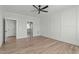 Spacious bedroom showcasing modern ceiling fan, trim work, and hardwood floors, offering both comfort and style at 100 Sire Ct, Holly Springs, NC 27540