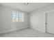 Bright bedroom with large window offering a view of trees and comfortable carpet at 100 Sire Ct, Holly Springs, NC 27540