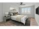 Staged bedroom features natural light, a comfortable bed, decorative pillows, and modern accents at 100 Sire Ct, Holly Springs, NC 27540