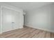 Bedroom featuring hardwood floors, white trim, with a closet and doorway leading to another room at 100 Sire Ct, Holly Springs, NC 27540