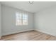 Bright bedroom with hardwood floors and a large window offering plenty of natural light at 100 Sire Ct, Holly Springs, NC 27540