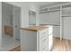 Walk-in closet with lots of shelving, rods for hanging clothes, and a butcher block island at 100 Sire Ct, Holly Springs, NC 27540