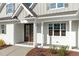 Close up of the front entrance featuring a dark wood double door with sidelight windows at 100 Sire Ct, Holly Springs, NC 27540
