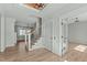 Bright hallway with hardwood floors, a staircase, and white trim, with doors to other rooms at 100 Sire Ct, Holly Springs, NC 27540