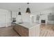 Spacious kitchen with a large island, stainless steel appliances, and an open floor plan at 100 Sire Ct, Holly Springs, NC 27540
