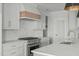 Beautiful kitchen with white cabinets, stainless appliances, and a large sink at 100 Sire Ct, Holly Springs, NC 27540