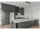 Well-appointed kitchen featuring custom cabinetry, a center island with quartz countertops, and stainless steel appliances at 100 Sire Ct, Holly Springs, NC 27540