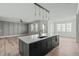 Open concept kitchen with a large island, modern appliances, and stylish pendant lighting at 100 Sire Ct, Holly Springs, NC 27540