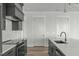 Modern kitchen featuring stainless steel appliances, shaker style cabinets, and a large island with a sink at 100 Sire Ct, Holly Springs, NC 27540