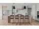 Modern kitchen featuring a large island, stylish pendant lighting, and wood cabinets at 100 Sire Ct, Holly Springs, NC 27540