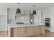 Well-designed kitchen with a large island, pendant lights, and stainless steel appliances at 100 Sire Ct, Holly Springs, NC 27540
