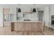 Modern kitchen featuring a large island, stylish pendant lighting, and light wood cabinets at 100 Sire Ct, Holly Springs, NC 27540