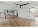 Open-concept living space with hardwood floors, a modern staircase, and a stylish kitchen at 100 Sire Ct, Holly Springs, NC 27540