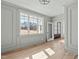 Bright living area with hardwood floors, large windows, and an open entryway at 100 Sire Ct, Holly Springs, NC 27540