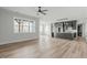 Bright, open living space showcasing hardwood floors, large windows, and a stylish kitchen with a central island at 100 Sire Ct, Holly Springs, NC 27540