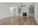 Bright living room featuring a fireplace, custom built-ins, and open staircase at 100 Sire Ct, Holly Springs, NC 27540