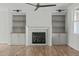 This living room showcases a fireplace and built-in shelves, perfect for storage or display at 100 Sire Ct, Holly Springs, NC 27540