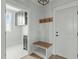 Functional mudroom features storage cabinets, a bench, and convenient coat hooks at 100 Sire Ct, Holly Springs, NC 27540