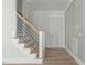 Stairway with wood steps and modern black metal railings at 100 Sire Ct, Holly Springs, NC 27540