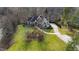 Sprawling property showcasing a meticulously maintained lawn and a winding driveway leading to the residence at 1004 Colworth Way, Raleigh, NC 27614