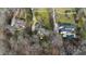 Stunning aerial view of home, landscaped yard, and surrounding neighborhood with mature trees and winding roads at 1004 Colworth Way, Raleigh, NC 27614