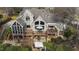 An aerial view of the home with a large deck, screened porch and backyard patio at 1004 Colworth Way, Raleigh, NC 27614