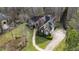 Aerial view of the house and landscaped yard, showing the driveway, mature trees, and surrounding landscape at 1004 Colworth Way, Raleigh, NC 27614