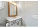 Stylish half bath featuring a vanity with quartz counters and modern fixtures and finishes at 1004 Colworth Way, Raleigh, NC 27614
