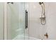 Modern bathroom shower featuring black hardware, glass door, and a handheld shower head at 1004 Colworth Way, Raleigh, NC 27614