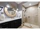 Stylish bathroom with round mirror and modern glass door shower at 1004 Colworth Way, Raleigh, NC 27614